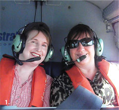 Senior Representative Karen Hooper (left) and Economist Marileze van Zyl of the Queensland State Office, on board a helicopter over Curtis Island