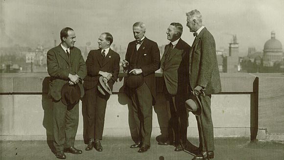 Photograph showing overseas pressmen (accompanying the Prince of Wales) talking with Denison Miller (middle).