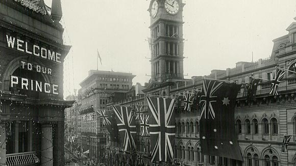 Photograph showing the lower part of Martin Place (looking up towards Pitt Street) decorated for the Prince's visit. The GPO (General Post Office) is in the foreground.