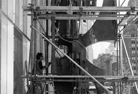 Margel Hinder works on her sculpture outside the Reserve Bank of Australia, 27 October 1964. In September 1961, the Governor of the Reserve Bank, Dr H.C.Coombs, announced an Australia-wide competition for artists and sculptors to design a freestanding sculpture, a mural wall design for the entrance foyer and a formal garden. The American–born artist Margel Hinder was awarded the commission for the sculpture, and her copper and steel artwork is a significant example of Australian modernist abstraction.